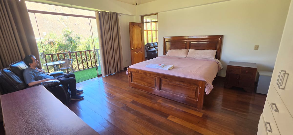 Habitación con cama king y balcón privado con vista al valle